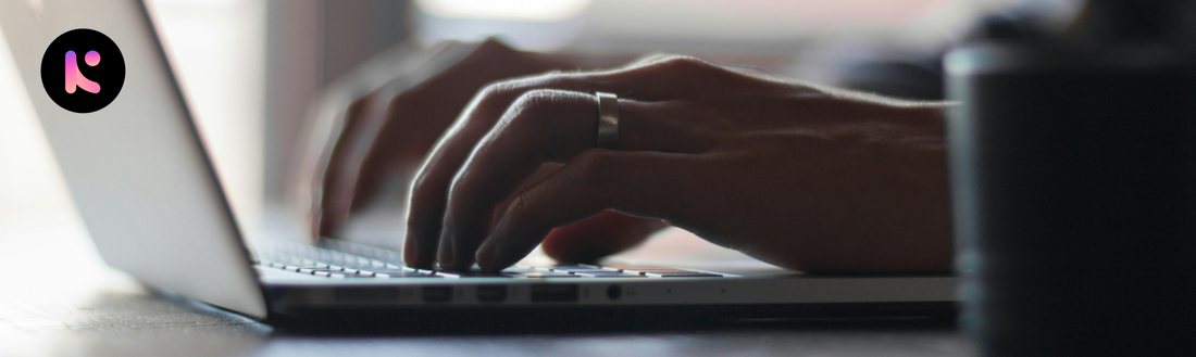 Close-up of hands typing on a laptop in low light, representing focused work once notifications are under control.